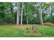 This backyard features a lush lawn and mature trees at 2543 Asbury Court Ct, Decatur, GA 30033