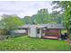 This backyard features a well-manicured lawn with mature trees at 2543 Asbury Court Ct, Decatur, GA 30033