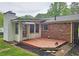 This exterior elevation features a brick facade and a wood deck at 2543 Asbury Court Ct, Decatur, GA 30033