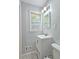 Charming bathroom features a gray vanity and a mirror above the sink; toilet and window nearby at 2543 Asbury Court Ct, Decatur, GA 30033