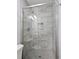 Bathroom showcasing glass-door shower with tiled walls and floors and brushed metal fixtures at 2543 Asbury Court Ct, Decatur, GA 30033