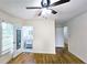 Spacious bedroom showcasing wood floors, a ceiling fan, and an ensuite bathroom with a glass door at 2543 Asbury Court Ct, Decatur, GA 30033