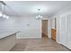 Dining area features modern lighting and wood-look flooring with access to a door and closet at 2543 Asbury Court Ct, Decatur, GA 30033