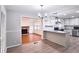 Open concept kitchen with granite countertops, stainless steel appliances, and modern lighting at 2543 Asbury Court Ct, Decatur, GA 30033