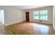 Hardwood floors and neutral walls with a window and wood door in the living room area at 2543 Asbury Court Ct, Decatur, GA 30033
