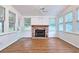Sunroom with hardwood flooring and brick fireplace is surrounded by windows providing natural light at 2543 Asbury Court Ct, Decatur, GA 30033