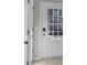 Bright entryway featuring a white door with glass panes, light-colored flooring, and neutral wall paint at 2766 Aralynn Way, College Park, GA 30337