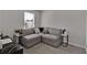 Stylish living room boasts a corner sectional couch, plush carpet, and an abundance of natural light at 2766 Aralynn Way, College Park, GA 30337