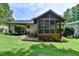 Backyard with green grass, a lattice deck, and lush trees on a beautiful day at 3232 Valaire Drive Dr, Decatur, GA 30033