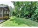 View of the home and the screened in porch from the large green backyard at 3232 Valaire Drive Dr, Decatur, GA 30033