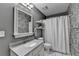Modern bathroom featuring decorative wallpaper, a well-lit mirror, and a shower with a floral curtain at 3232 Valaire Drive Dr, Decatur, GA 30033