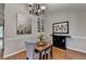 Dining room featuring hardwood floors, wainscoting, modern art, and a decorative chandelier at 3232 Valaire Drive Dr, Decatur, GA 30033