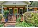 Inviting front porch with brick steps, dark shutters and lovely landscaping at 3232 Valaire Drive Dr, Decatur, GA 30033