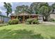 Charming red brick home featuring a lush front yard and well-manicured landscaping at 3232 Valaire Drive Dr, Decatur, GA 30033