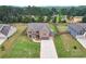 Aerial view of a brick home with a long driveway, spacious front and back yards, and wooden fence at 109 Jodi Pl, Locust Grove, GA 30248