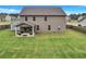 Large backyard featuring a covered patio with outdoor seating, ideal for entertaining at 109 Jodi Pl, Locust Grove, GA 30248