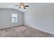 Neutral bedroom with carpeted floor, ceiling fan, and window, creating a serene and comfortable atmosphere at 109 Jodi Pl, Locust Grove, GA 30248