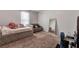 Cozy bedroom with a comfortable bed, a sofa, and a full-length mirror, perfect for relaxing and unwinding at 109 Jodi Pl, Locust Grove, GA 30248