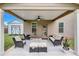Relaxing covered patio with ceiling fan and comfortable seating area at 109 Jodi Pl, Locust Grove, GA 30248