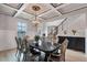 Elegant dining room featuring coffered ceilings, chandelier, and ornate dining set, perfect for entertaining guests at 109 Jodi Pl, Locust Grove, GA 30248