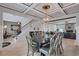 Well-lit dining area with hardwood floors, custom ceiling, and an open floor plan leading to the staircase and living room at 109 Jodi Pl, Locust Grove, GA 30248