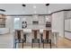 Bright kitchen with gray cabinets, pendant lighting, and island with chairs at 109 Jodi Pl, Locust Grove, GA 30248