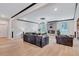 Comfortable living room with hardwood floors, a modern fireplace, and large windows providing an abundance of natural light at 109 Jodi Pl, Locust Grove, GA 30248