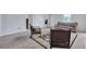 Upstairs bonus room with neutral colors, plush carpet, and decorative armchairs at 109 Jodi Pl, Locust Grove, GA 30248