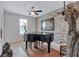 Elegant room with a grand piano and decorative stone wall, great as a music room at 109 Jodi Pl, Locust Grove, GA 30248