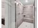 Tiled shower with built-in bench and glass enclosure, providing a comfortable and stylish showering experience at 109 Jodi Pl, Locust Grove, GA 30248