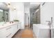 Bright bathroom featuring a modern tub, glass shower, and marble countertops at 167 Sampson Ne St, Atlanta, GA 30312