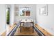 Modern dining room with a wooden table, white chairs, stylish lighting, and hardwood floors, creating a bright atmosphere at 167 Sampson Ne St, Atlanta, GA 30312