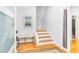 Inviting entryway with a bench, wood floors, stairway, and attractive decor at 167 Sampson Ne St, Atlanta, GA 30312