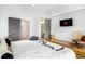 Serene main bedroom featuring a bed, TV, and gray sliding doors leading to the bathroom at 167 Sampson Ne St, Atlanta, GA 30312