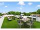 Inviting rooftop terrace featuring a dining area, lounge seating, artificial grass, and distant city views at 167 Sampson Ne St, Atlanta, GA 30312