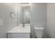 Bright bathroom featuring a white marble vanity top, brushed nickel faucet, and white toilet at 2732 Dahlonega Trl, Austell, GA 30106