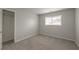 Bedroom featuring plush carpet, a window, and access to a closet for storage at 2732 Dahlonega Trl, Austell, GA 30106