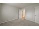 Bedroom with neutral walls, carpet, and a view into the hallway at 2732 Dahlonega Trl, Austell, GA 30106