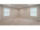 Spacious bedroom featuring two windows, plush carpeting, and neutral wall paint at 2732 Dahlonega Trl, Austell, GA 30106