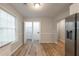 Open concept dining area with stainless refrigerator, wood floors, and open entrance to laundry at 2732 Dahlonega Trl, Austell, GA 30106