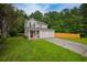 Charming two-story home with a well-maintained lawn and a two-car garage nestled among green trees at 2732 Dahlonega Trl, Austell, GA 30106