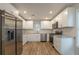 Bright kitchen with white cabinetry, stainless appliances, granite countertops, and wood-look floors at 2732 Dahlonega Trl, Austell, GA 30106