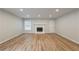 Modern living area featuring hardwood floors, a classic fireplace, and abundant natural light for a cozy atmosphere at 2732 Dahlonega Trl, Austell, GA 30106