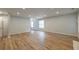 Expansive living area featuring sleek wood flooring and recessed lighting, creating an elegant and inviting space at 2732 Dahlonega Trl, Austell, GA 30106