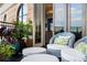 Outdoor seating area on a balcony with brick accent wall and an arched window at 3286 Northside Nw Pkwy # Ph2, Atlanta, GA 30327