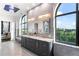 Bright bathroom featuring marble countertops, dual sinks, arched windows, and serene views at 3286 Northside Nw Pkwy # Ph2, Atlanta, GA 30327