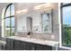 Bright bathroom with double vanity, marble countertop, and large window overlooking lush greenery at 3286 Northside Nw Pkwy # Ph2, Atlanta, GA 30327