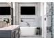 Luxurious bathroom featuring a standalone tub, marble accents, and a wall-mounted television at 3286 Northside Nw Pkwy # Ph2, Atlanta, GA 30327