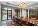 Elegant dining room featuring a large table, chandelier, and courtyard access, perfect for gatherings at 3286 Northside Nw Pkwy # Ph2, Atlanta, GA 30327