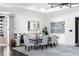 Dining room with a sleek table, patterned chairs, modern art, and a view to the home's custom display cabinet at 3286 Northside Nw Pkwy # Ph2, Atlanta, GA 30327